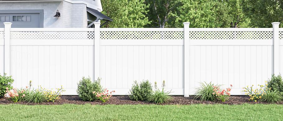 Finished white vinyl fence around a residential yard